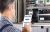 Close-up Of A Male Technician Doing Meter Reading Using Mobilephone